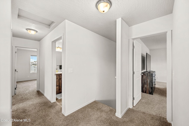 3664 W Belgrave Way, Hayden, ID 83835 - corridor featuring carpet floors, attic access, and a textured ceiling