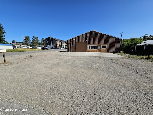 503 E Railroad Ave, Post Falls, ID 83854 - view of home's exterior featuring a garage, an outbuilding, and board and batten siding