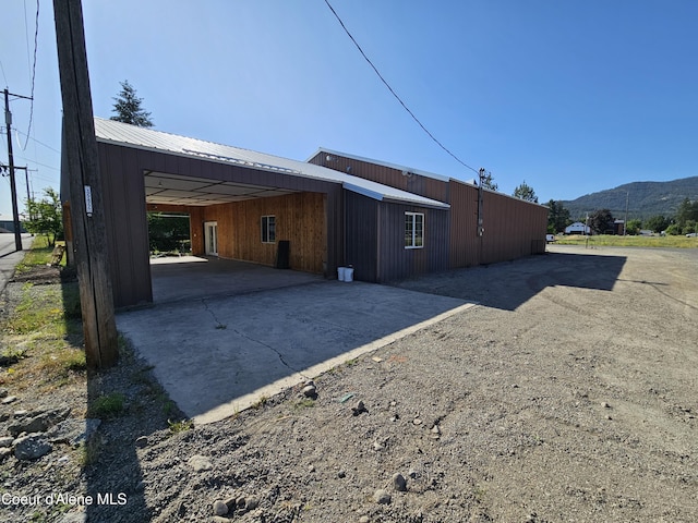 503 E Railroad Ave, Post Falls, ID 83854 - view of home's exterior featuring concrete driveway, a mountain view, and a carport