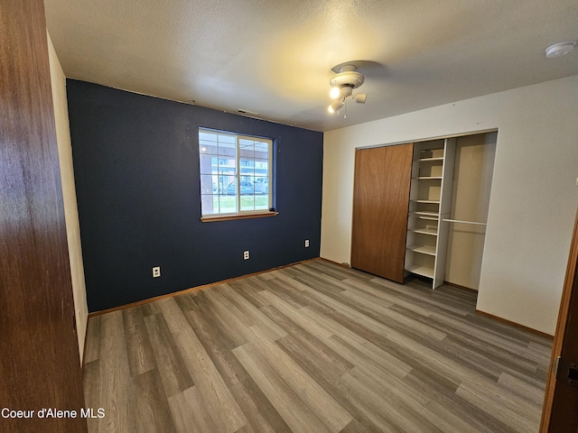 503 E Railroad Ave, Post Falls, ID 83854 - unfurnished bedroom with wood finished floors and a closet