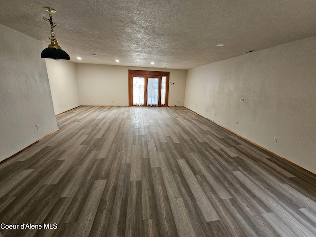503 E Railroad Ave, Post Falls, ID 83854 - unfurnished living room featuring wood finished floors, a textured ceiling, and recessed lighting