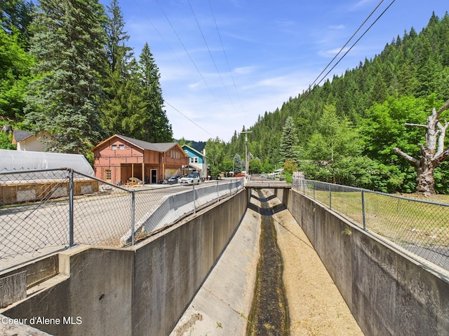 185 King St, Wallace, ID 83873 - view of patio featuring a wooded view