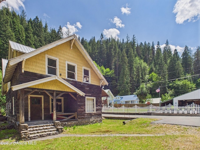 185 King St, Wallace, ID 83873 - view of front of property featuring covered porch and a view of trees