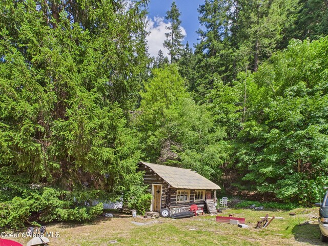 185 King St, Wallace, ID 83873 - view of grassy yard with a view of trees