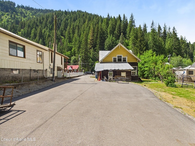 185 King St, Wallace, ID 83873 - view of asphalt driveway with a view of trees
