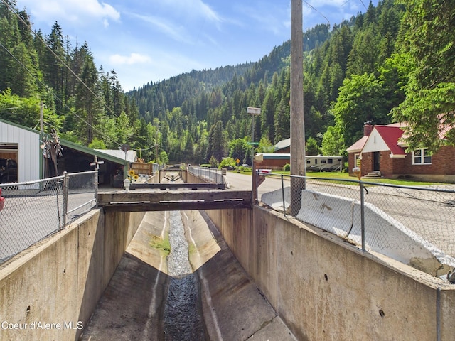185 King St, Wallace, ID 83873 - view of patio featuring a wooded view