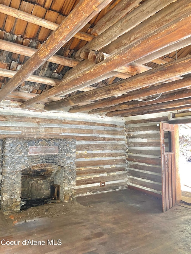 185 King St, Wallace, ID 83873 - unfurnished living room featuring wood finished floors and a stone fireplace