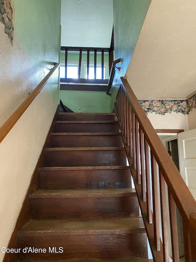 185 King St, Wallace, ID 83873 - staircase with a textured wall