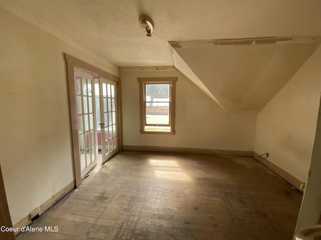 185 King St, Wallace, ID 83873 - additional living space featuring french doors, vaulted ceiling, and wood-type flooring