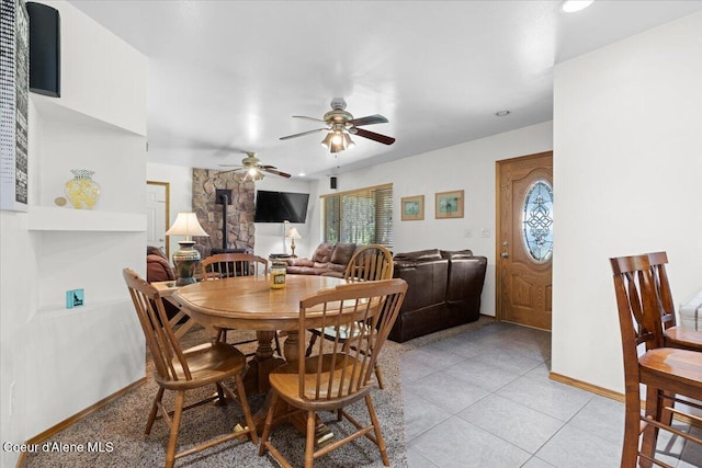 174 Where Its At Rd, Athol, ID 83801 - dining area featuring a wood stove, a ceiling fan, and light tile patterned floors
