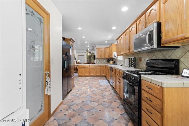 174 Where Its At Rd, Athol, ID 83801 - kitchen featuring black appliances, decorative backsplash, recessed lighting, tile counters, and ceiling fan