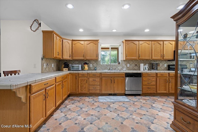 174 Where Its At Rd, Athol, ID 83801 - kitchen featuring stainless steel dishwasher, tile countertops, backsplash, recessed lighting, and brown cabinets