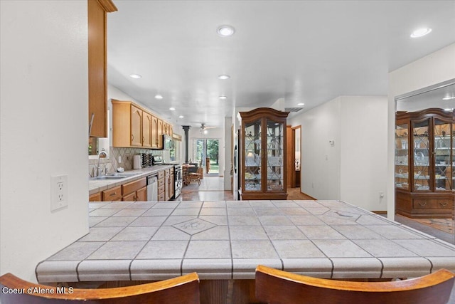 174 Where Its At Rd, Athol, ID 83801 - kitchen with tile counters, stainless steel appliances, recessed lighting, and decorative backsplash