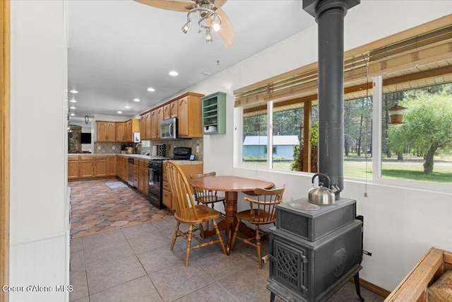 174 Where Its At Rd, Athol, ID 83801 - dining room featuring a wood stove, recessed lighting, light tile patterned floors, and a ceiling fan