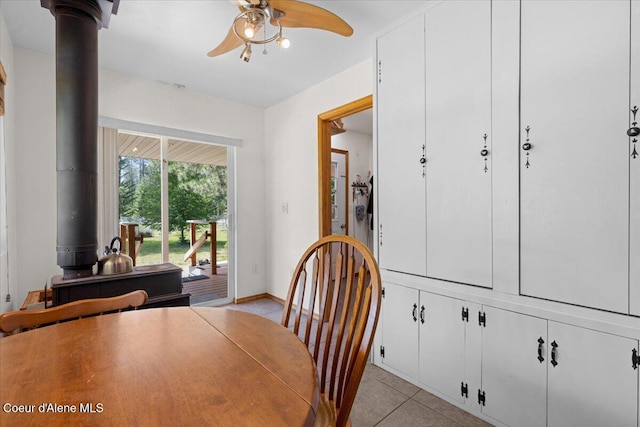 174 Where Its At Rd, Athol, ID 83801 - dining space featuring a ceiling fan, a wood stove, and light tile patterned floors