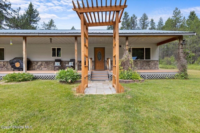 174 Where Its At Rd, Athol, ID 83801 - view of front of house featuring stone siding, covered porch, a front yard, and a metal roof
