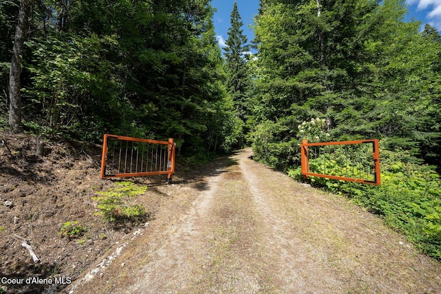1911 Carr Creek Rd, Sandpoint, ID 83864 - view of dirt / gravel road with a forest view and a gate
