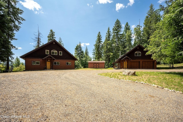 1911 Carr Creek Rd, Sandpoint, ID 83864 - view of front of home with an outdoor structure, driveway, and a detached garage