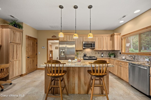 1911 Carr Creek Rd, Sandpoint, ID 83864 - kitchen with appliances with stainless steel finishes, light brown cabinets, and decorative backsplash