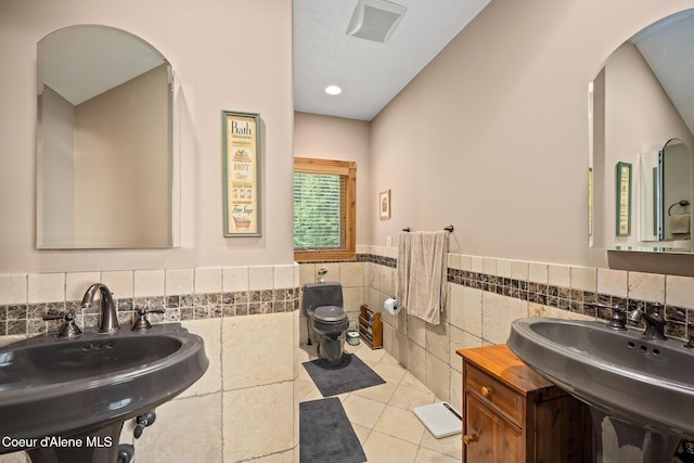 1911 Carr Creek Rd, Sandpoint, ID 83864 - bathroom featuring tile walls, wainscoting, and tile patterned flooring