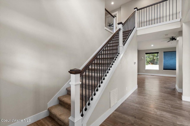 1877 W Orchard Ave, Hayden, ID 83835 - staircase featuring wood finished floors, ceiling fan, a towering ceiling, and recessed lighting