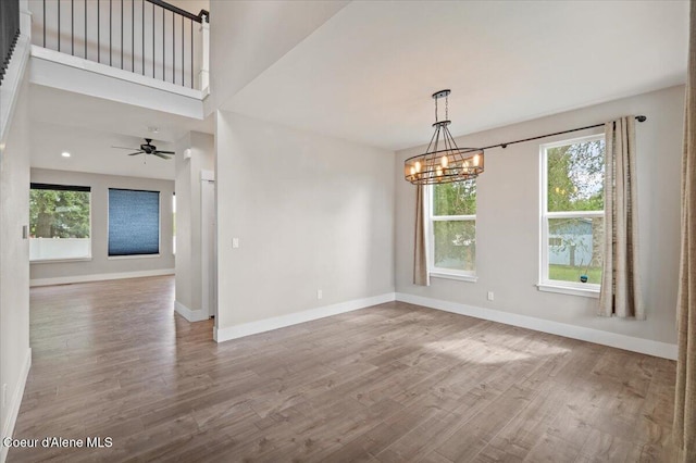 1877 W Orchard Ave, Hayden, ID 83835 - spare room featuring wood finished floors, a chandelier, and ceiling fan