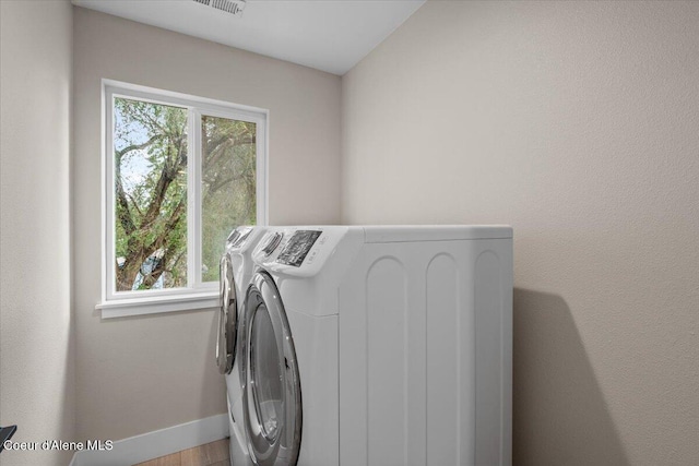 1877 W Orchard Ave, Hayden, ID 83835 - laundry area featuring independent washer and dryer and wood finished floors
