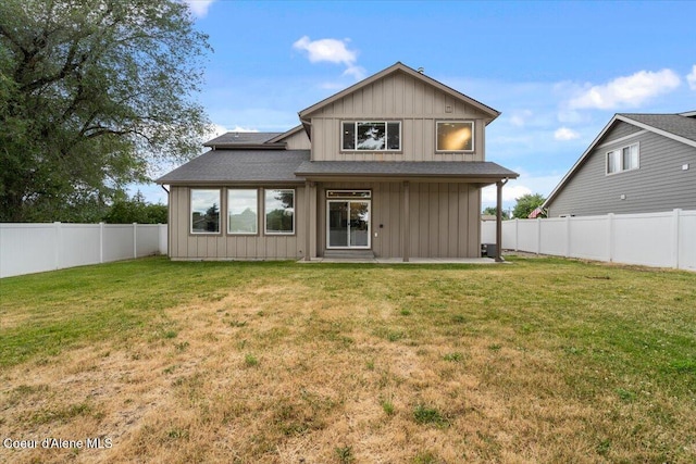 1877 W Orchard Ave, Hayden, ID 83835 - back of property with board and batten siding, a fenced backyard, and roof with shingles