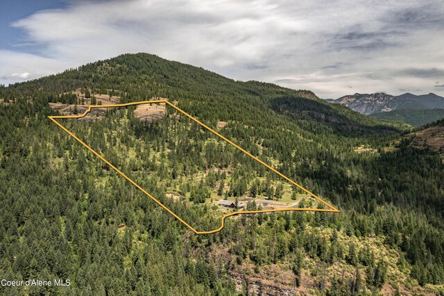 1010 Mc Quade Gulch Dr, Clark Fork, ID 83811 - aerial overview of property's location with a mountainous background and property parcel outlined