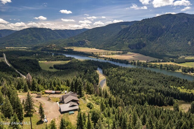 1010 Mc Quade Gulch Dr, Clark Fork, ID 83811 - view of mountain backdrop featuring a nearby body of water and a heavily wooded area