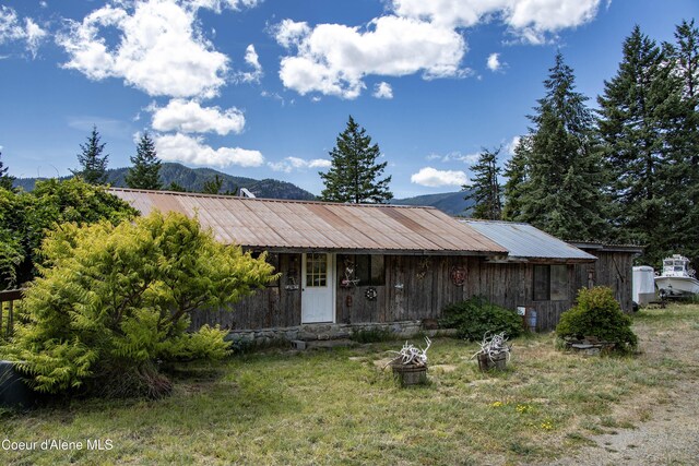 1010 Mc Quade Gulch Dr, Clark Fork, ID 83811 - view of front of house featuring a metal roof, a mountain view, and covered porch