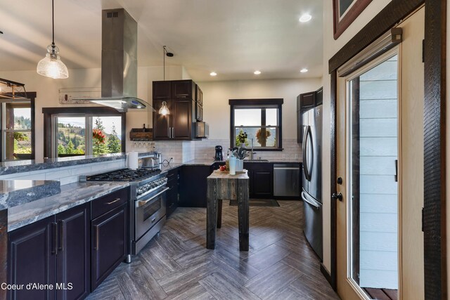 1010 Mc Quade Gulch Dr, Clark Fork, ID 83811 - kitchen featuring stainless steel appliances, island exhaust hood, light stone counters, tasteful backsplash, and recessed lighting