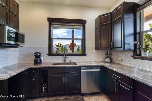 1010 Mc Quade Gulch Dr, Clark Fork, ID 83811 - kitchen featuring stainless steel appliances, light stone countertops, and backsplash