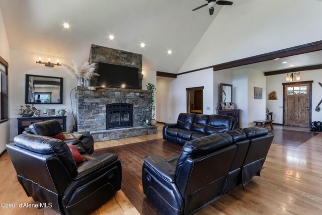 1010 Mc Quade Gulch Dr, Clark Fork, ID 83811 - living room with a ceiling fan, wood finished floors, a stone fireplace, high vaulted ceiling, and recessed lighting