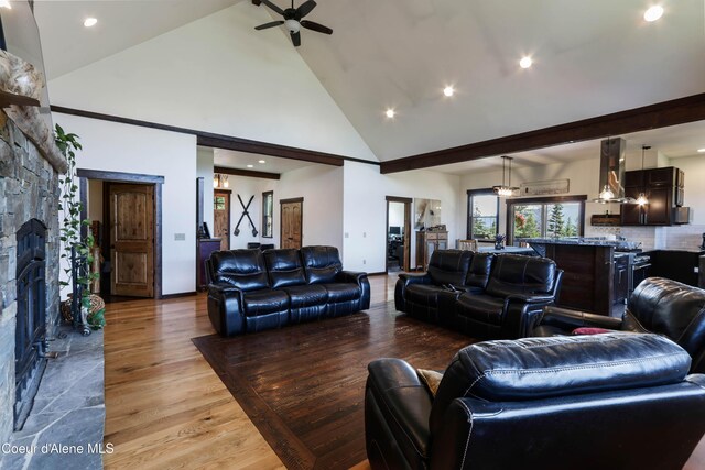 1010 Mc Quade Gulch Dr, Clark Fork, ID 83811 - living area with high vaulted ceiling, a ceiling fan, a stone fireplace, recessed lighting, and light wood finished floors