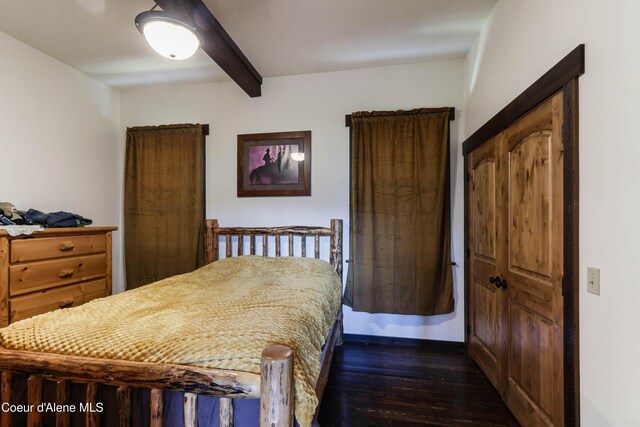 1010 Mc Quade Gulch Dr, Clark Fork, ID 83811 - bedroom featuring beamed ceiling and dark wood-style flooring