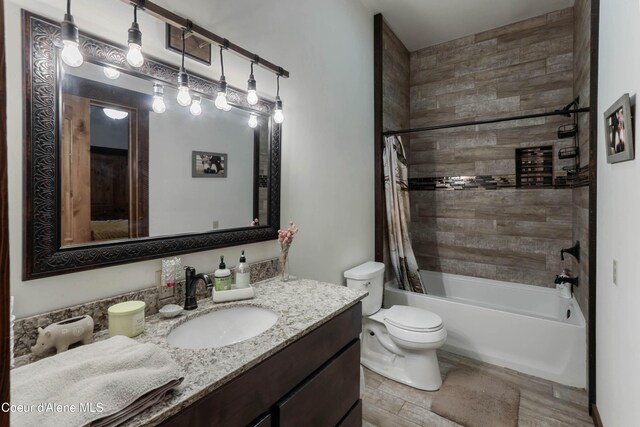 1010 Mc Quade Gulch Dr, Clark Fork, ID 83811 - full bathroom featuring vanity, shower / tub combo with curtain, and wood finished floors