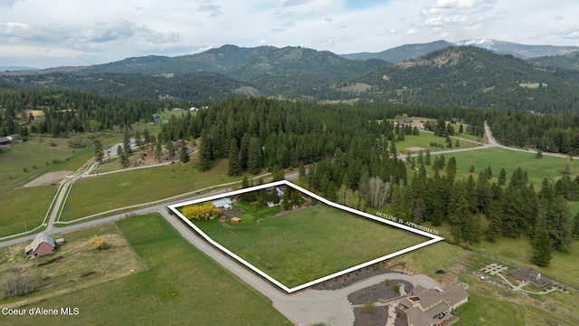 5570 E Dodd Rd, Hayden, ID 83835 - aerial view of property and surrounding area with mountains, property boundaries highlighted, and rural landscape