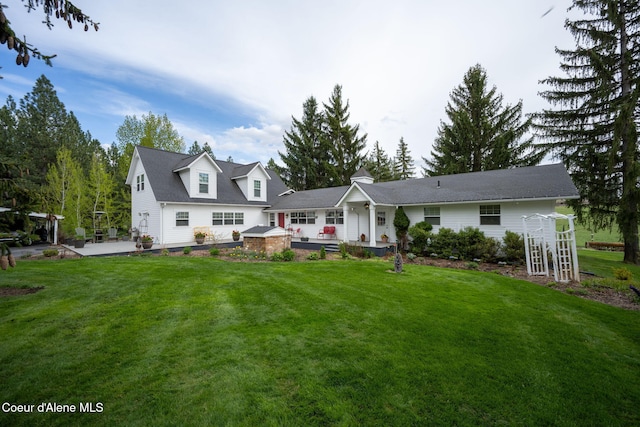 5570 E Dodd Rd, Hayden, ID 83835 - rear view of property featuring a lawn and a patio