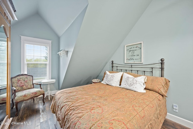 5570 E Dodd Rd, Hayden, ID 83835 - bedroom featuring vaulted ceiling and dark wood-style flooring