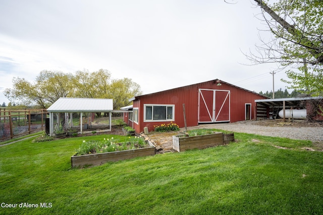 5570 E Dodd Rd, Hayden, ID 83835 - view of outbuilding with a vegetable garden