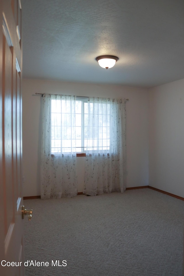 1276 W Edgewood Cir, Coeur Dalene, ID 83815 - unfurnished room with healthy amount of natural light and carpet floors