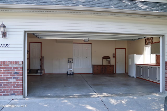 1276 W Edgewood Cir, Coeur Dalene, ID 83815 - garage featuring freestanding refrigerator