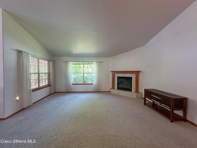 1276 W Edgewood Cir, Coeur Dalene, ID 83815 - unfurnished living room featuring lofted ceiling, a fireplace, and carpet floors