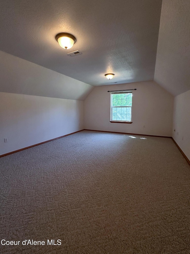 1276 W Edgewood Cir, Coeur Dalene, ID 83815 - bonus room featuring lofted ceiling, carpet, and a textured ceiling