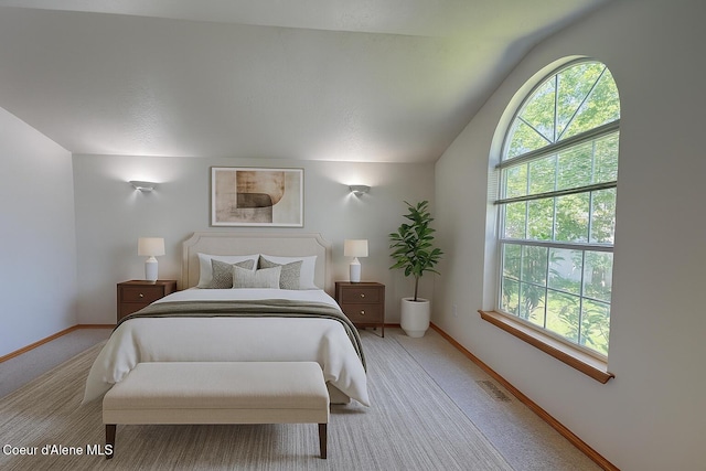 1276 W Edgewood Cir, Coeur Dalene, ID 83815 - bedroom featuring multiple windows, vaulted ceiling, and light carpet