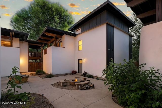 1106 Larch St Unit A, Sandpoint, ID 83864 - rear view of property featuring a fire pit, a patio, and stucco siding