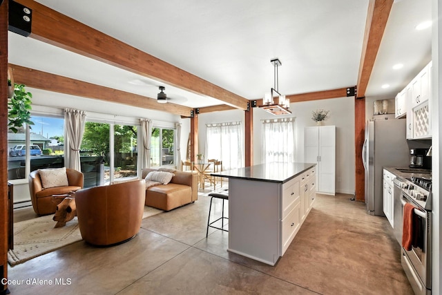 1106 Larch St Unit A, Sandpoint, ID 83864 - kitchen featuring beam ceiling, dark countertops, open floor plan, concrete flooring, and a breakfast bar area