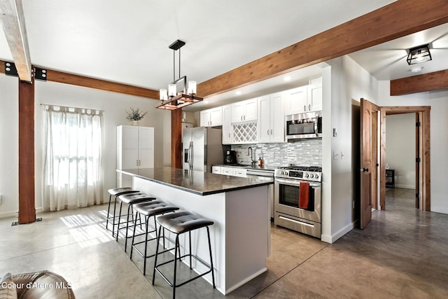1106 Larch St Unit A, Sandpoint, ID 83864 - kitchen with appliances with stainless steel finishes, beamed ceiling, tasteful backsplash, finished concrete flooring, and a breakfast bar area