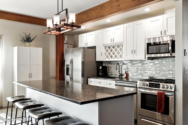 1106 Larch St Unit A, Sandpoint, ID 83864 - kitchen featuring stainless steel appliances, beam ceiling, tasteful backsplash, white cabinets, and a chandelier